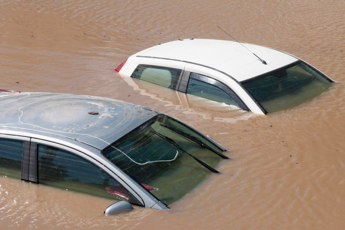 Roofs of two cars come out of the water during a flood.